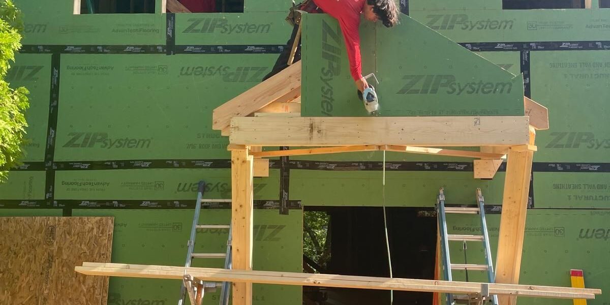 Luminous Construction carpenter installing structural wood framing with ZIP System wall sheathing in Natick MA