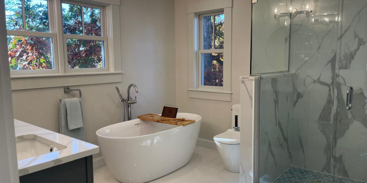 Luxury master bathroom renovation with freestanding soaking tub and marble walk-in shower in Needham MA
