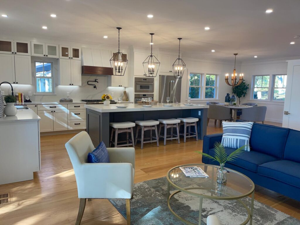 Open concept architectural living room and kitchen design build transformation in MA with hardwood flooring