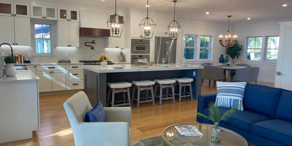 Open concept living room and luxury custom kitchen remodeling with center island and hardwood floors