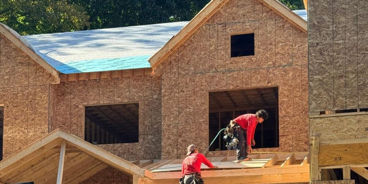 Carpenters framing roof decking and installing roof underlayment for home addition in Southborough MA