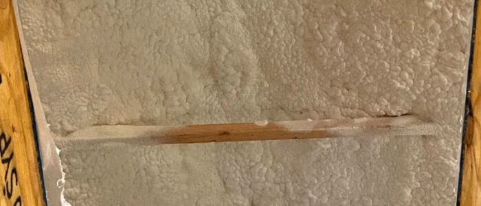 Closed cell spray foam insulation applied between wall studs for high-efficiency thermal performance