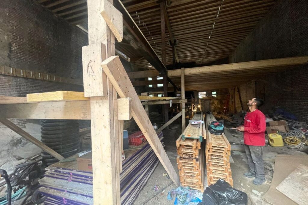 Interior historic brick wall restoration and structural support framing in Boston MA