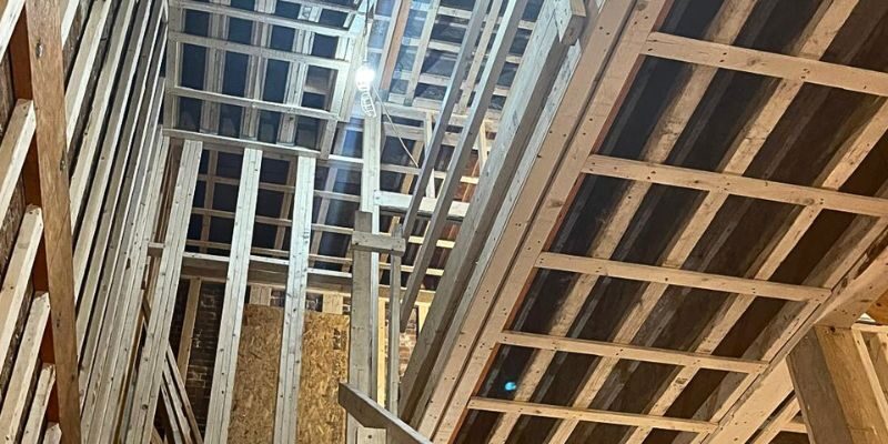 Multi-story brick historic brownstone building with exterior scaffolding setup for facade restoration in Boston
