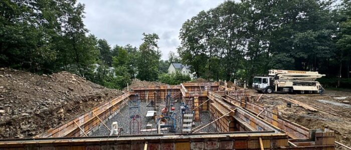 Concrete foundation forms and site preparation for structural home addition by general contractor in Ashland MA