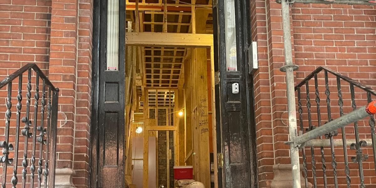 Luminous Construction executing structural interior wood framing inside historic brick building entrance in Concord MA