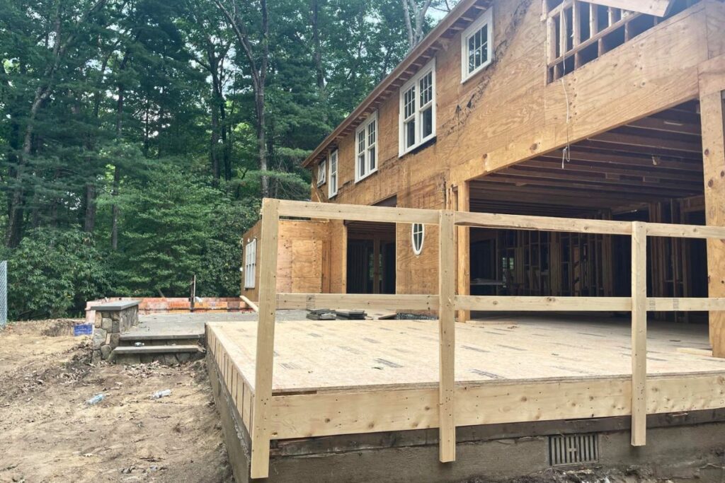 Structural wood framing and deck construction for whole house gut renovation in Wellesley MA