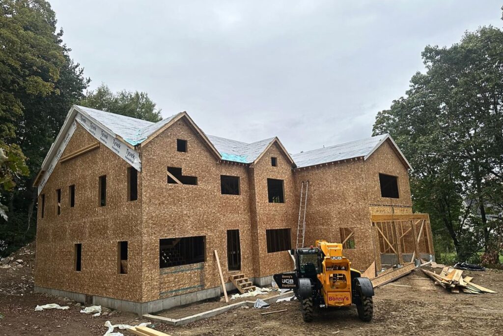 New roof sheathing and synthetic underlayment installation on two story residential home in Massachusetts